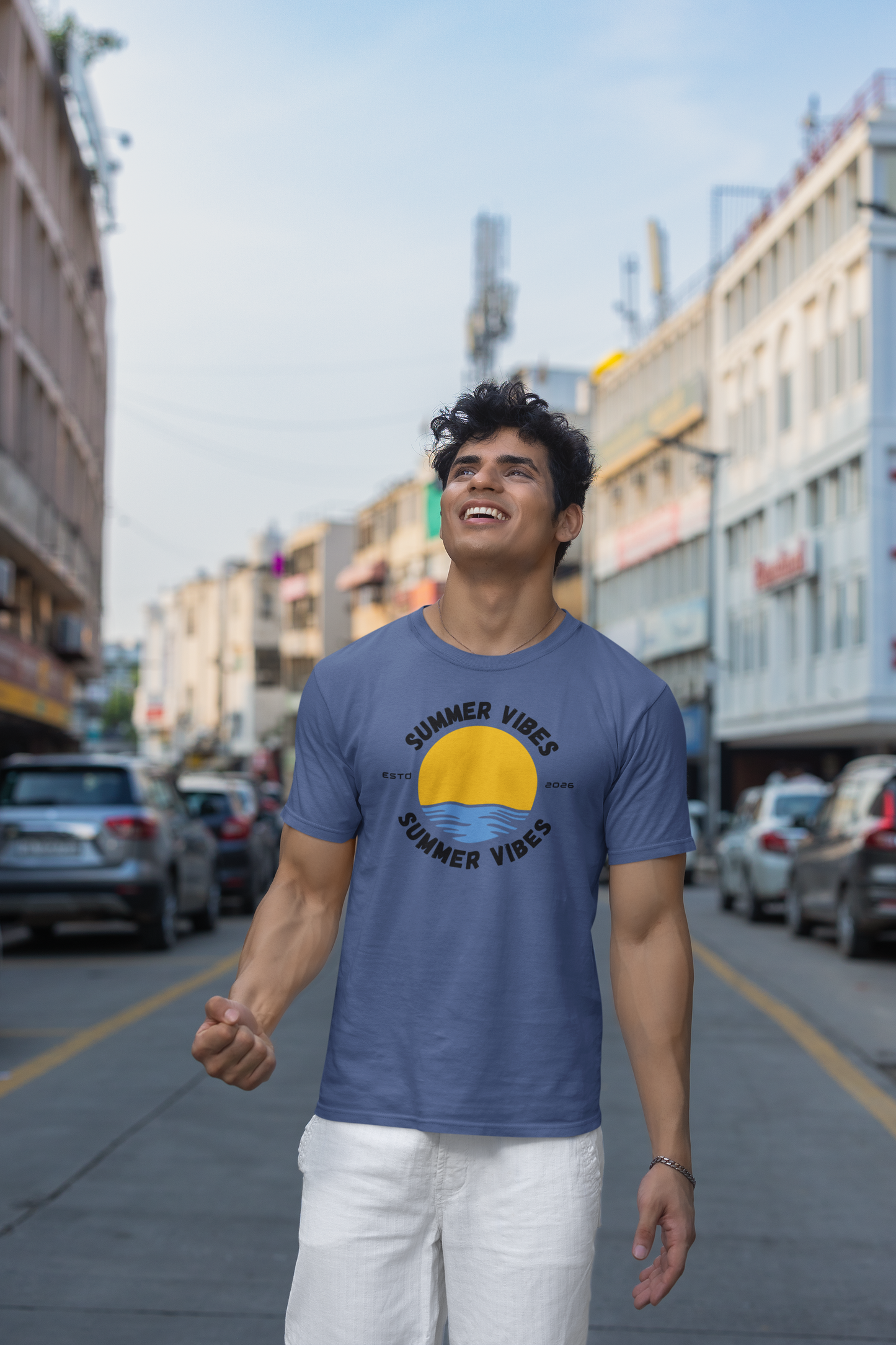 Man wearing a smoke blue 'Summer Vibes' t-shirt on a city street