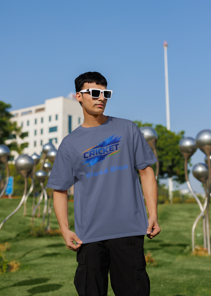 Person wearing a steel grey t-shirt with a colorful graphic design outdoors on a sunny day.