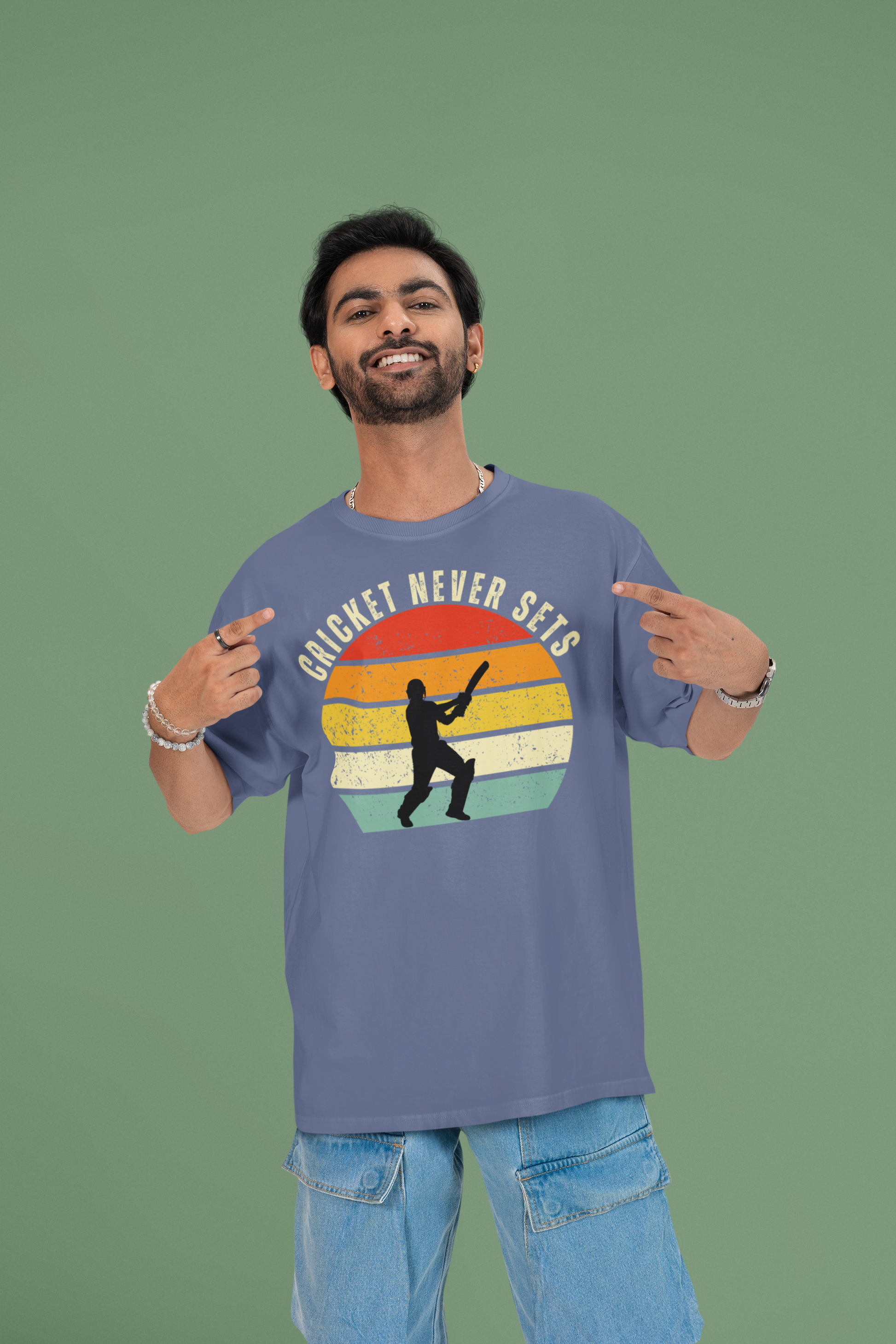 Man wearing a cricket never sets steel grey t-shirt with a colorful graphic and text