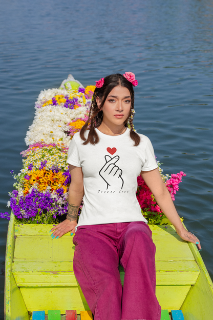 Woman wearing a white t-shirt with a design on a boat decorated with flowers