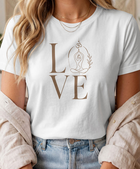 A woman modelling a white graphic t-shirt featuring a minimalist "LOVE" design with a meditating yoga pose and an Om symbol
