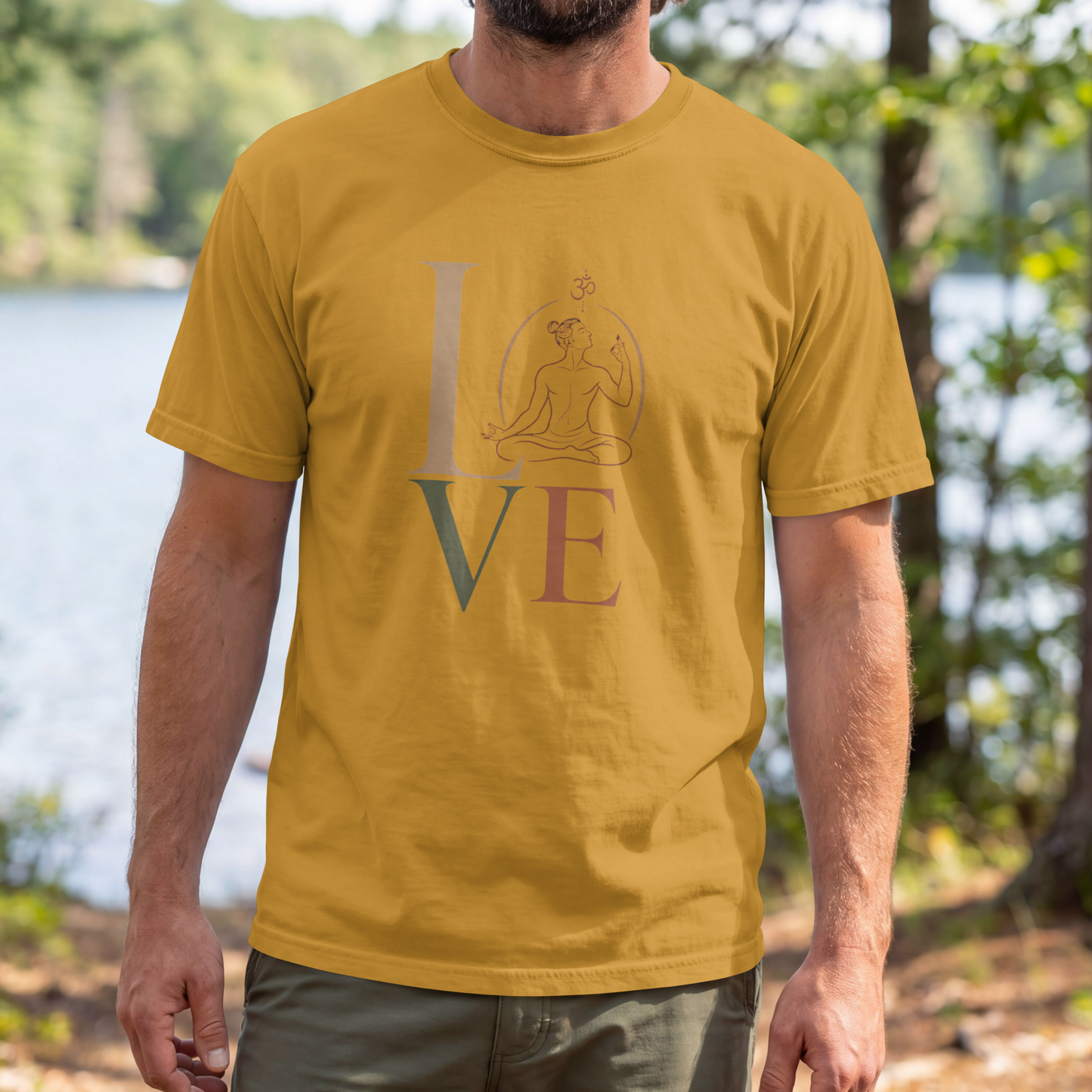 A man modelling a mustard yellow graphic t-shirt featuring a minimalist "LOVE" design with a meditating yoga pose and an Om symbol