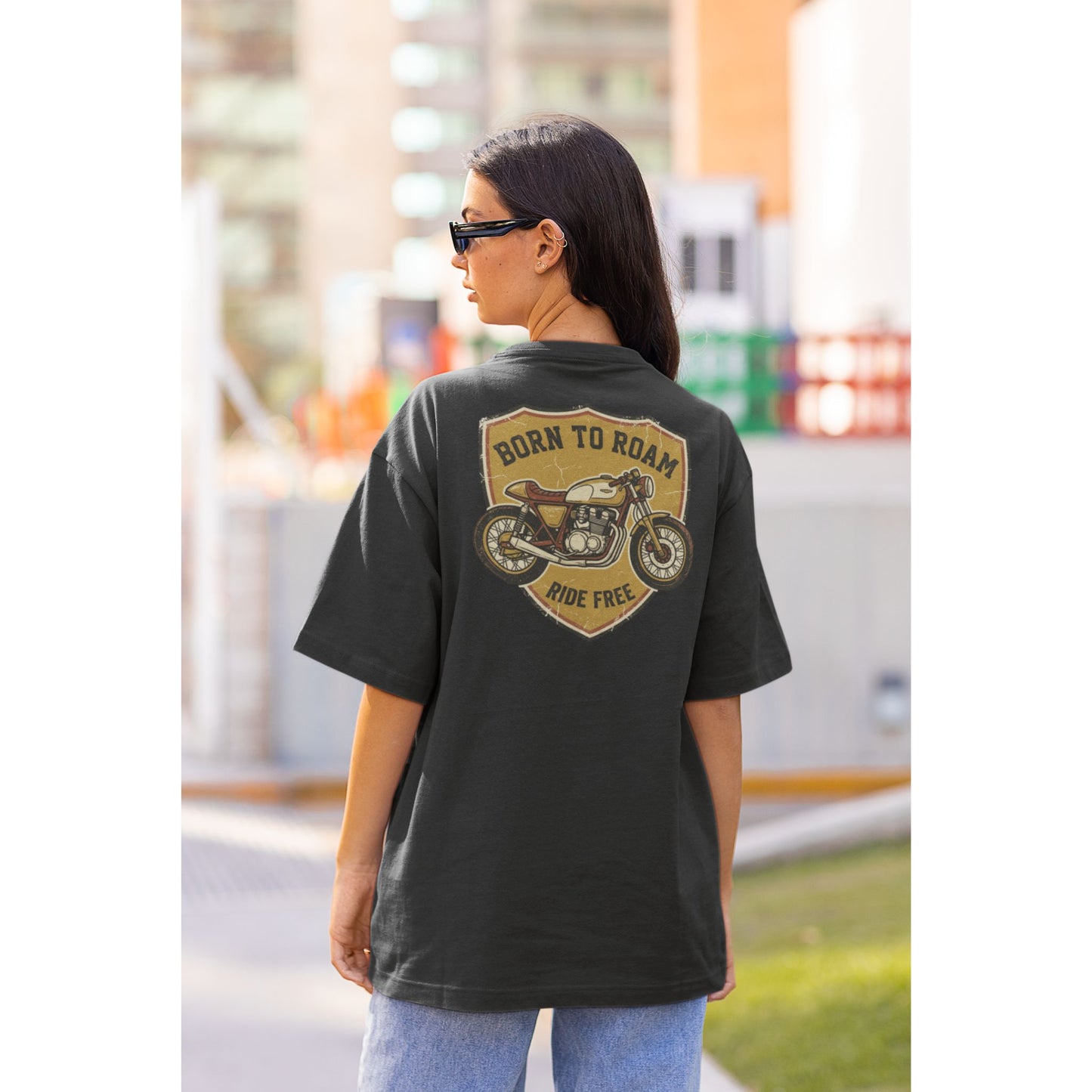 Female model wearing the Nauma Born To Roam cafe racer oversized t-shirt in Black, boxy unisex fit