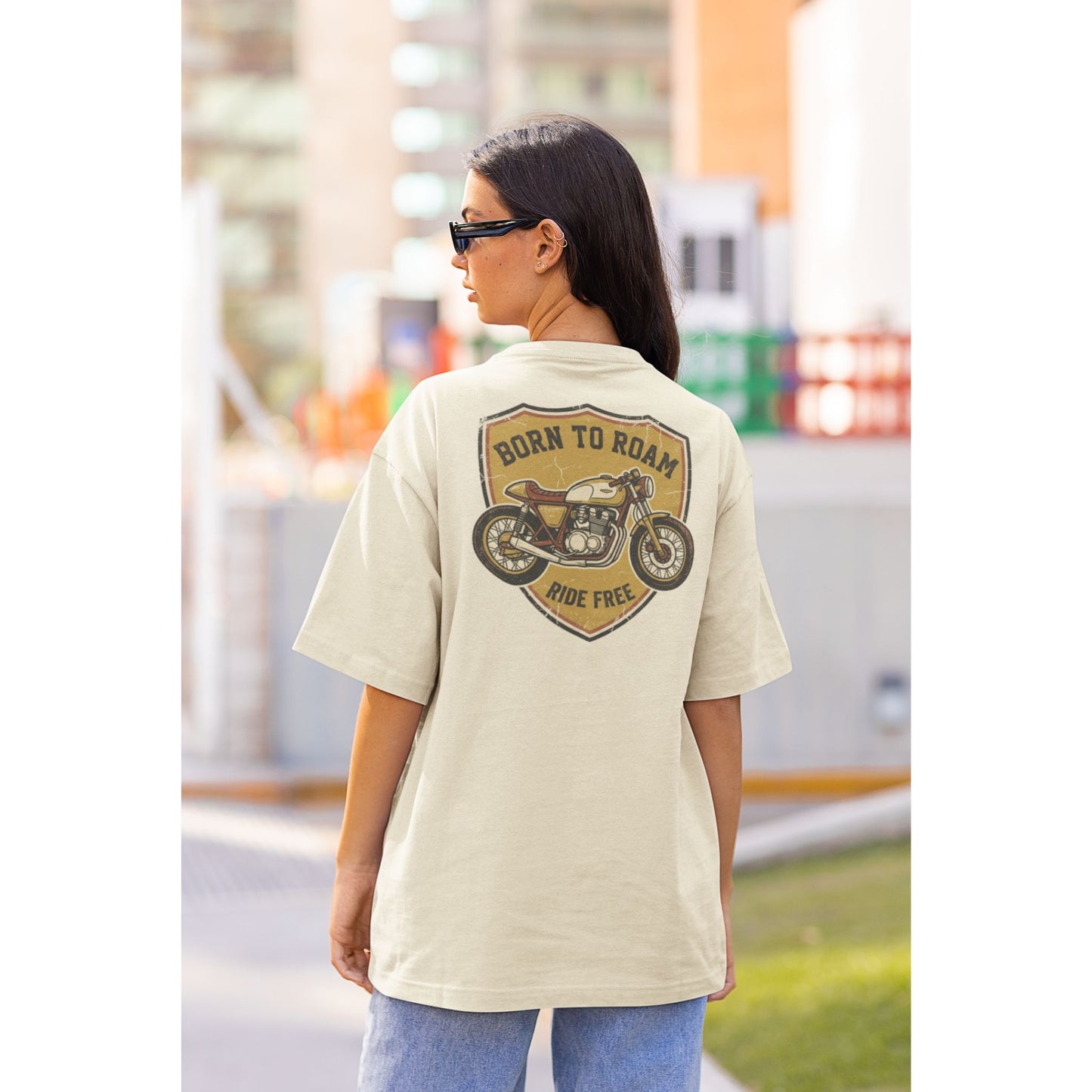 Female model wearing the Nauma Born To Roam cafe racer oversized t-shirt in Off White, boxy unisex fit