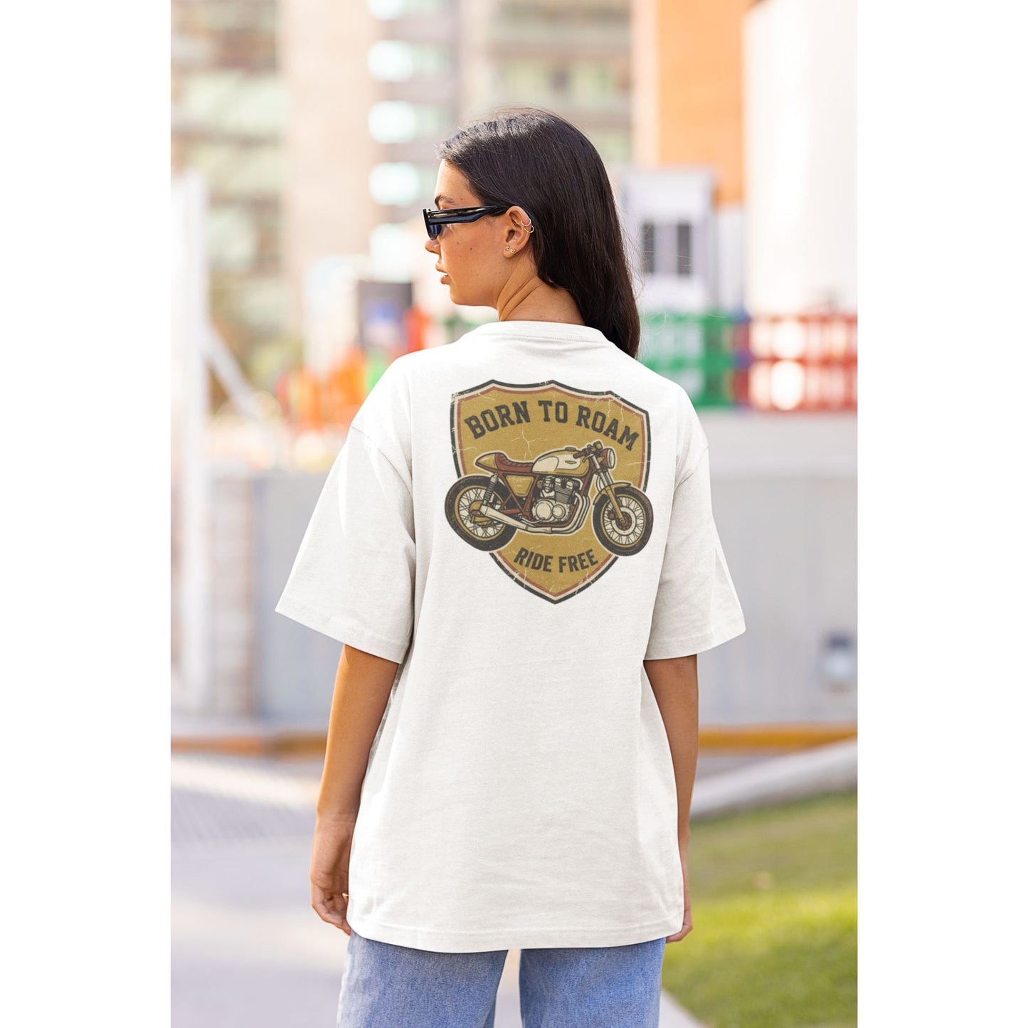 Female model wearing the Nauma Born To Roam cafe racer oversized t-shirt in White, boxy unisex fit