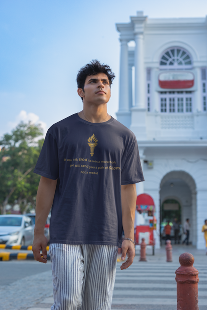 Navy Blue baggy fit t-shirt for men with a gold-toned torch illustration and "Shoes not a Medal" quote.