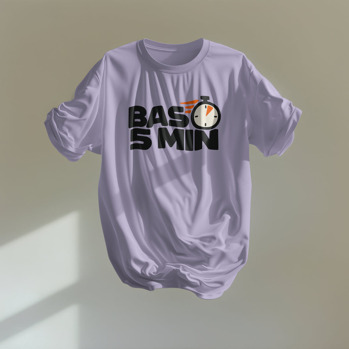 Lavender Bas 5 Min oversized t-shirt floating against a plain wall, black stopwatch slogan print with orange speed lines