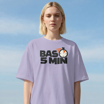 Lavender Bas 5 Min unisex oversized t-shirt worn by a woman outdoors, stopwatch slogan print on the chest
