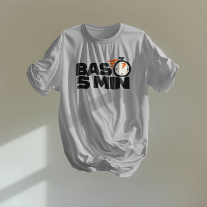 Melange Grey Bas 5 Min oversized t-shirt floating against a sunlit wall, black BAS 5 MIN lettering with an orange-accented stopwatch