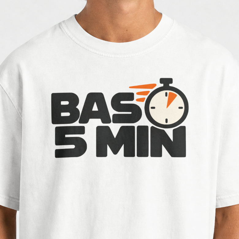 White Bas 5 Min tee print close-up, bold black slogan with an orange wedge on the stopwatch dial