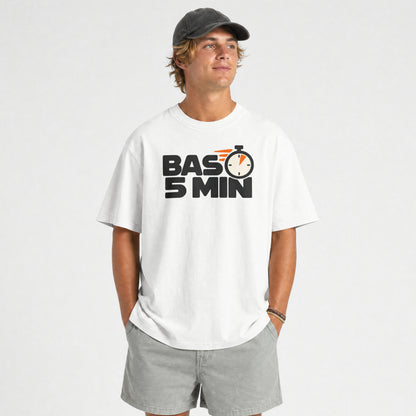 White Bas 5 Min funny Hinglish oversized t-shirt worn by a smiling man with grey shorts, front print visible