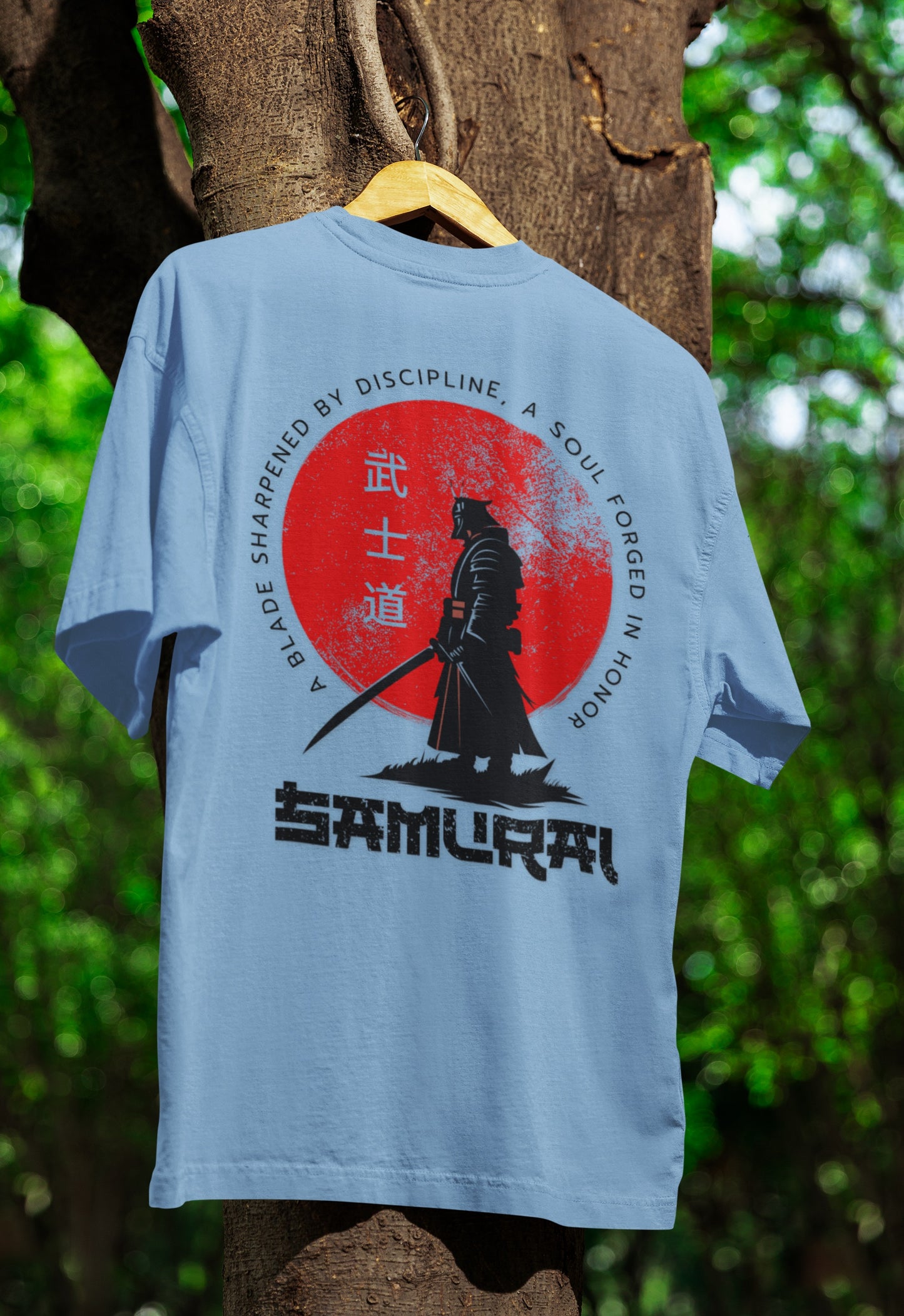 Flat lay of Nauma Bushido Discipline baby blue oversized T-shirt with samurai graphic