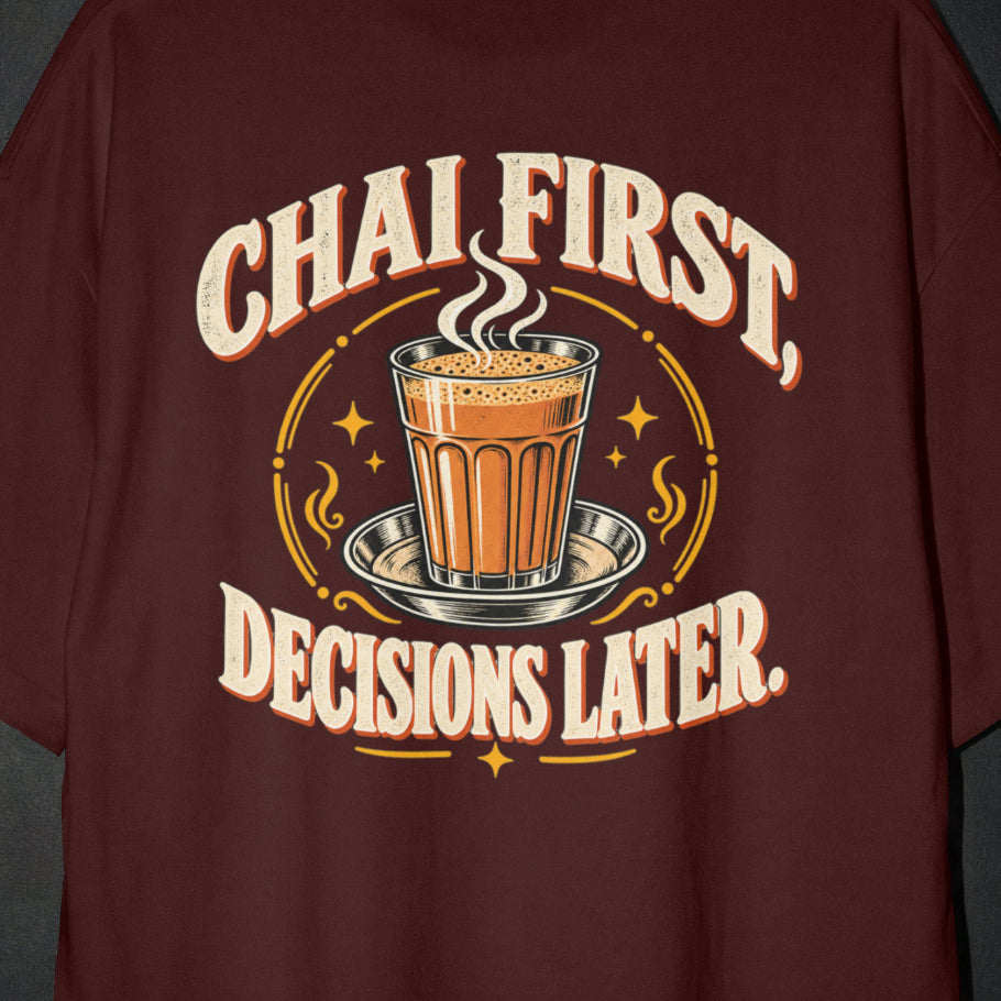 Maroon Chai First Decisions Later T-shirt print close-up: cream retro lettering around a steaming cutting chai glass on a steel saucer