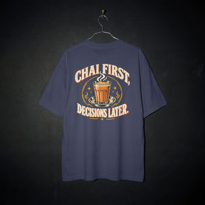 Navy Blue Chai First Decisions Later oversized T-shirt on a hanger against a dark backdrop, front view of the cutting chai graphic print