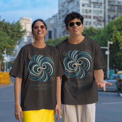 Two models wearing black Nauma oversized t-shirts with a teal and gold colliding black holes print