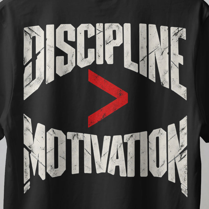 Black Discipline Over Motivation back print close-up, cracked off-white letters with a red greater-than sign