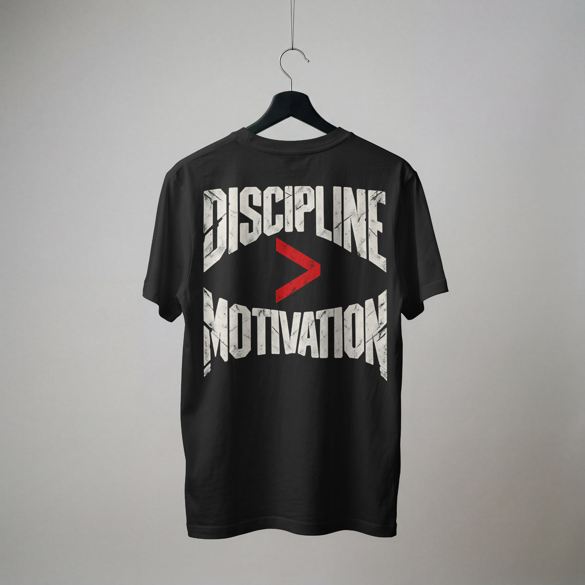 Black Discipline Over Motivation oversized t-shirt on a hanger, showing the back print