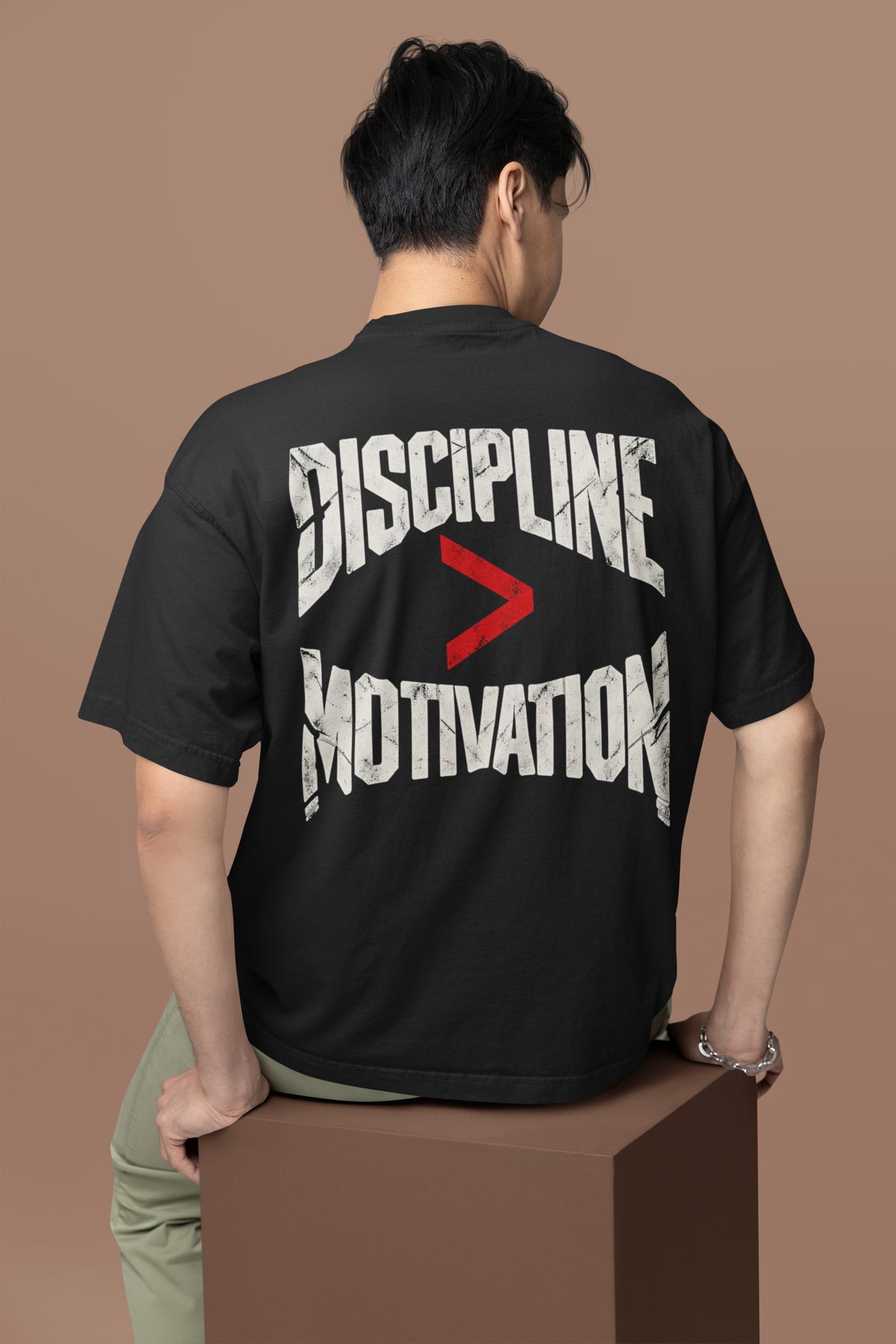 Black Discipline Over Motivation back print unisex oversized t-shirt worn by a man, back view