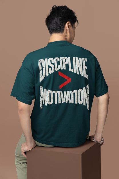 Petrol Blue Discipline Over Motivation back print unisex oversized t-shirt worn by a man, back view