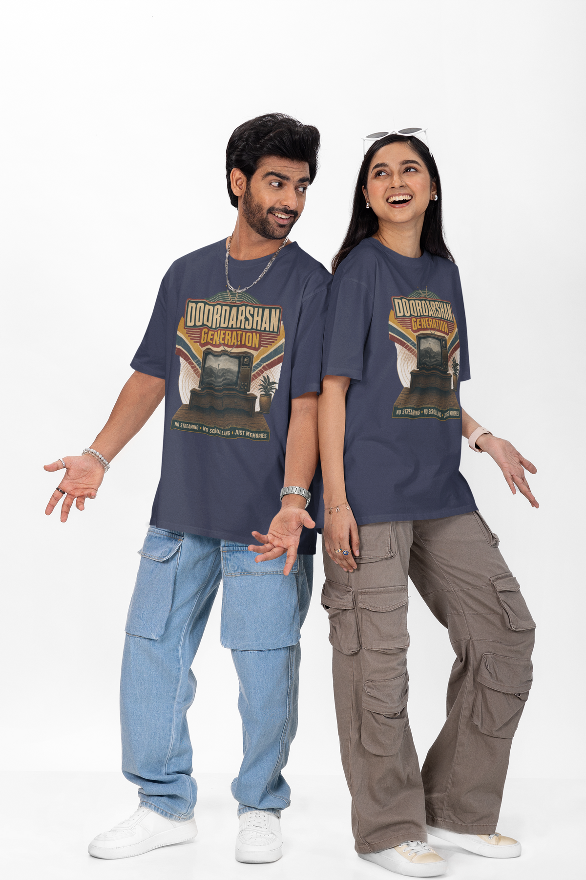 Man and woman wearing the Navy Blue Doordarshan Generation oversized t-shirt with baggy jeans on a plain backdrop