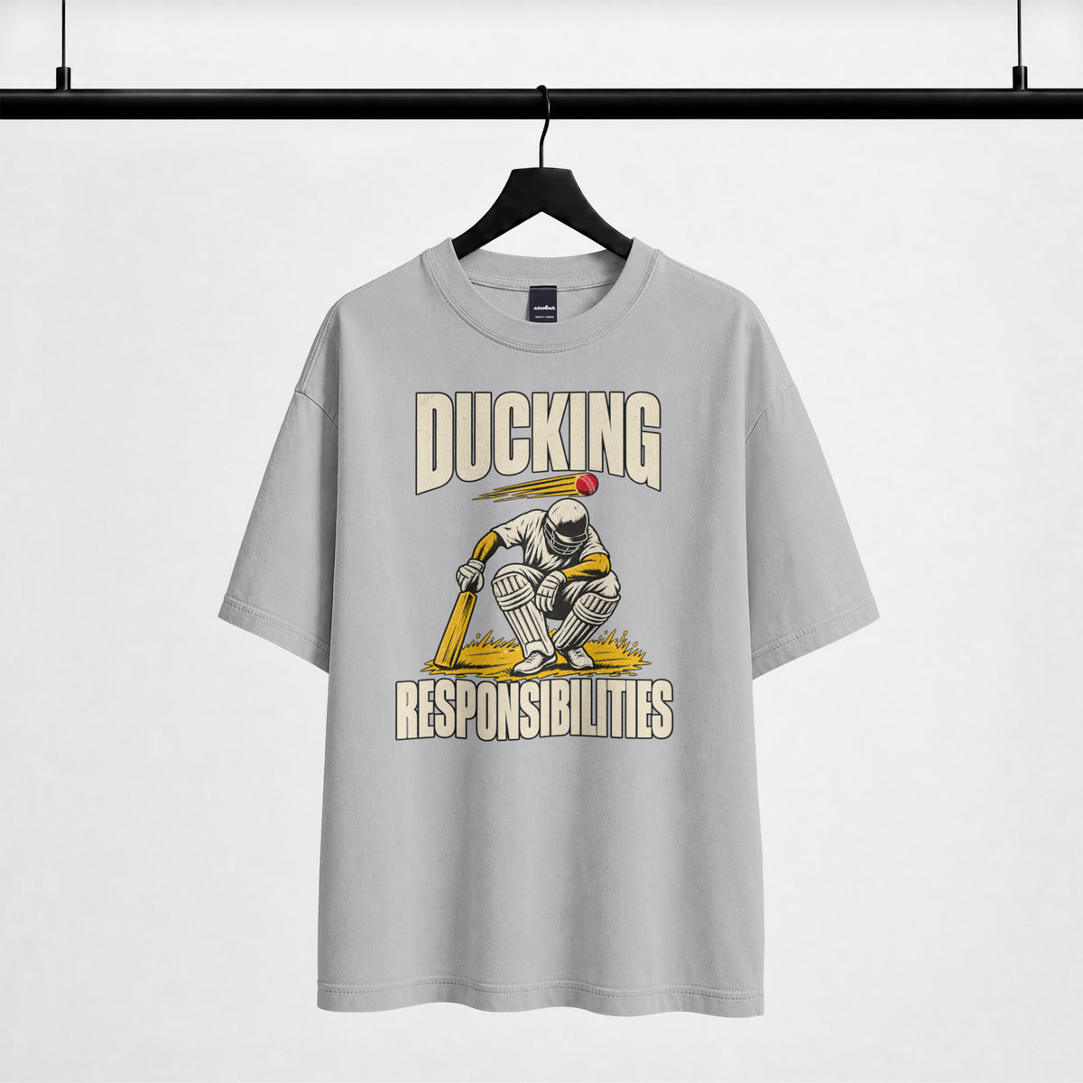 Melange grey Ducking Responsibilities oversized T-shirt on a hanger, vintage-style cricket batter print with bold lettering