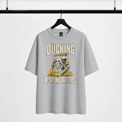 Melange grey Ducking Responsibilities oversized T-shirt on a hanger, vintage-style cricket batter print with bold lettering