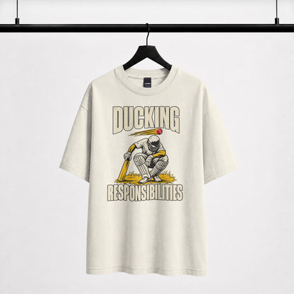 Off white Ducking Responsibilities oversized T-shirt on a hanger, cricket batter crouching under a flying red ball