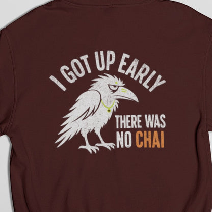 Close-up of white crow and I got up early there was no chai back print on Maroon hoodie