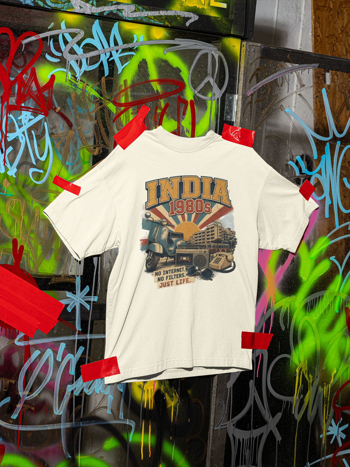 Off white India 80s oversized t-shirt on a graffiti wall showing the INDIA 1980s front graphic