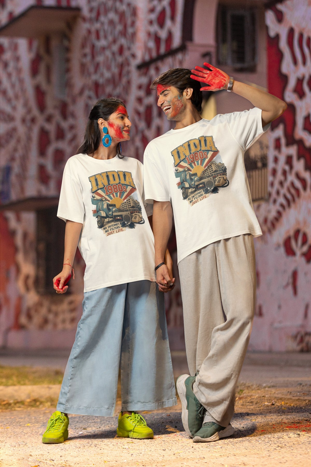 Man and woman wearing the India 80s retro oversized t-shirt in Off white with relaxed wide-leg trousers