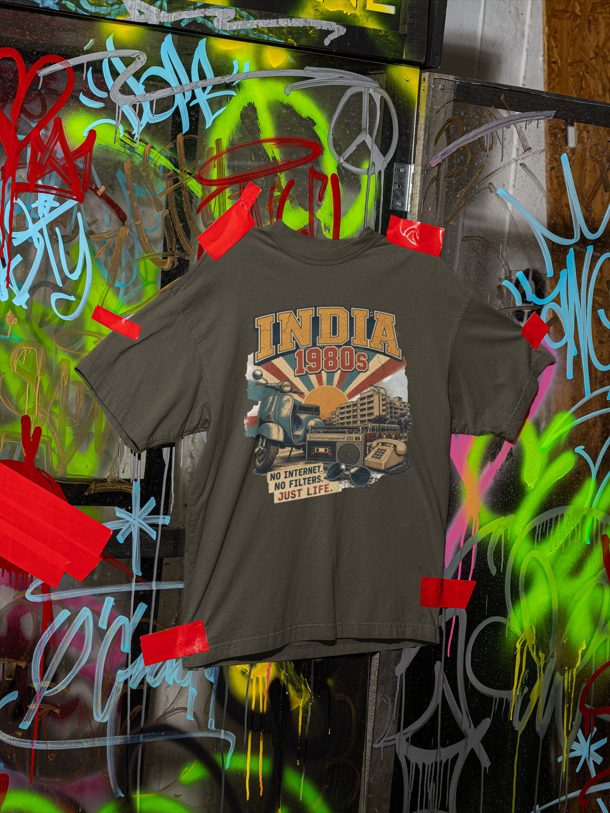 Olive Green India 80s retro oversized t-shirt flat front view against street graffiti
