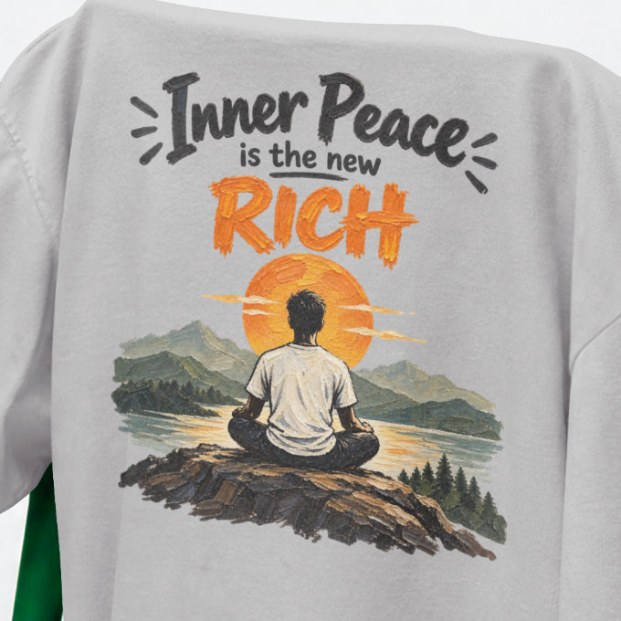 Melange Grey Inner Peace Is The New Rich print close-up, a figure meditating on a rock facing an orange sunset over mountains and a lake