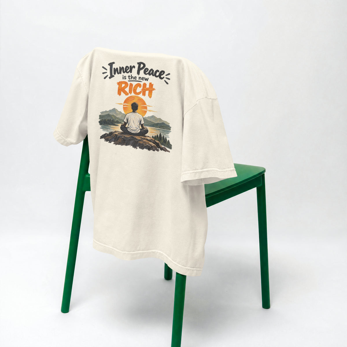 Off white Inner Peace Is The New Rich oversized t-shirt draped over a green chair, showing the front print