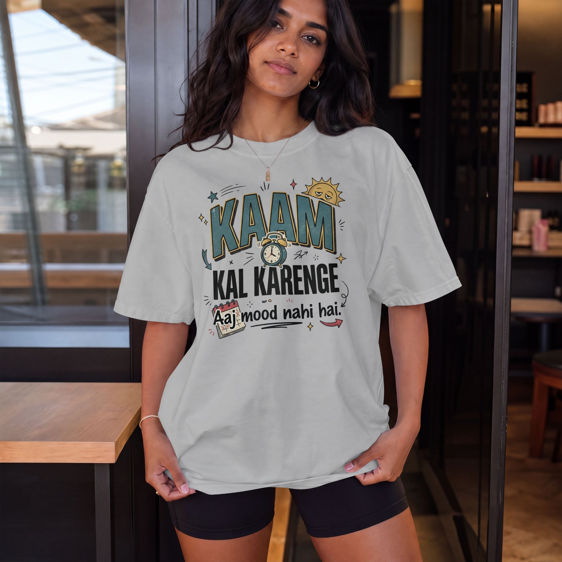Melange grey Nauma oversized t-shirt, model shot, with 'Kaam Kal Karenge' typography and playful doodle art.