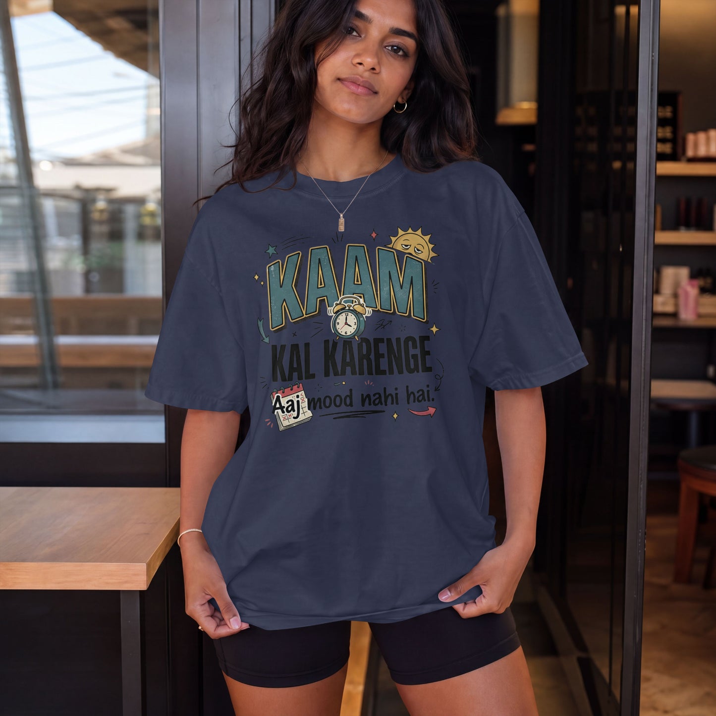 Navy blue Nauma oversized t-shirt, model shot, featuring 'Kaam Kal Karenge' bold typography and doodle artwork.