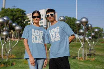 Baby Blue Log Kya Kahenge oversized t-shirt worn by a man and a woman in a park, distressed Hinglish slogan print across the chest