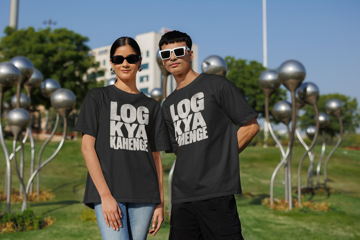 Black Log Kya Kahenge oversized t-shirt worn by a man and a woman in a park, distressed Hinglish slogan print across the chest