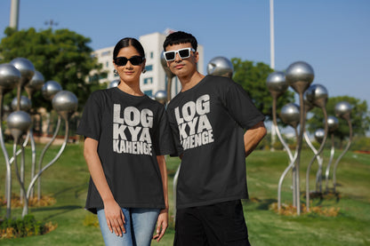 Black Log Kya Kahenge oversized t-shirt worn by a man and a woman in a park, distressed Hinglish slogan print across the chest