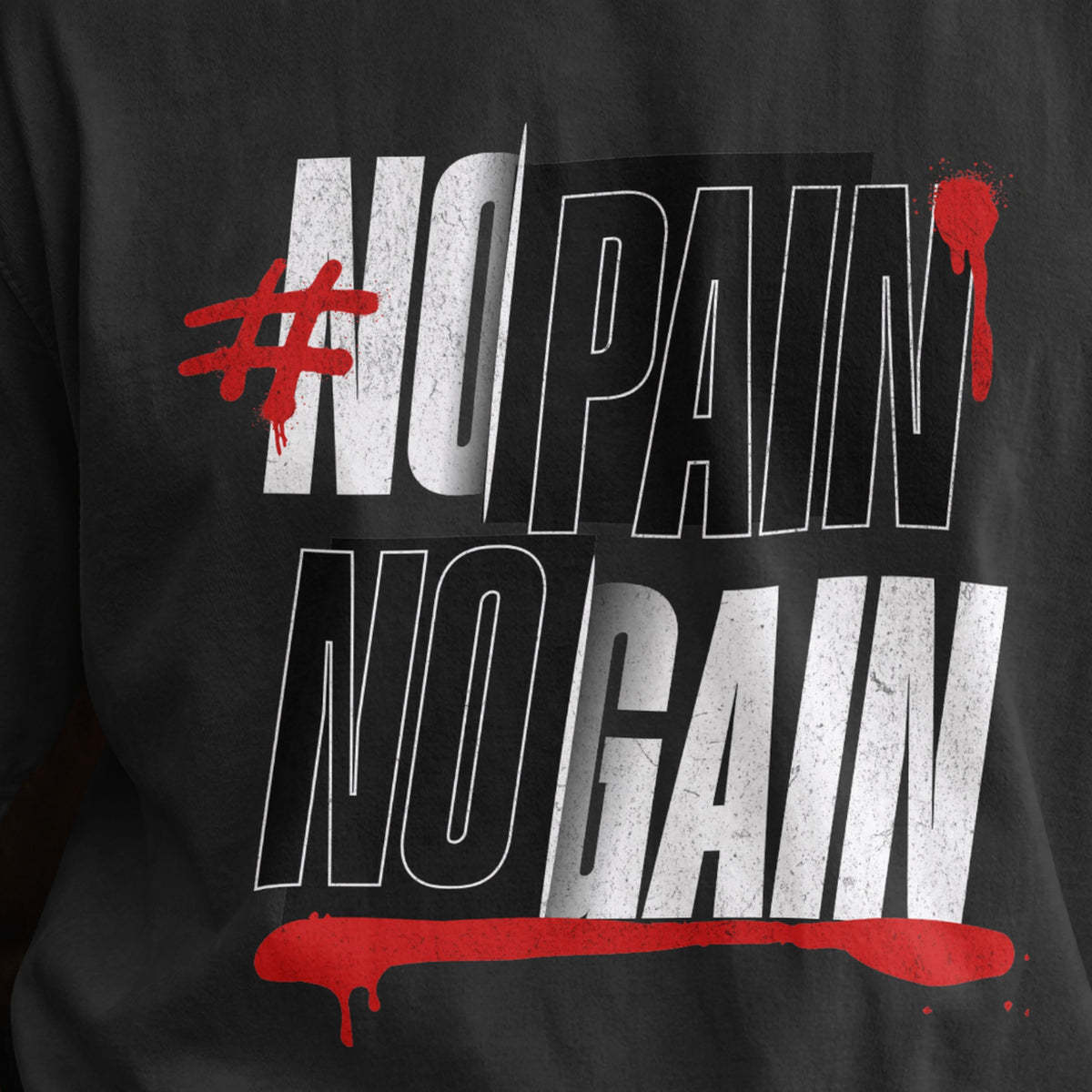 Close-up of the No Pain No Gain print on a black oversized T-shirt, distressed white and red gym typography