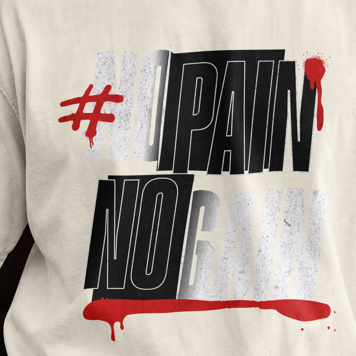 Close-up of the No Pain No Gain print on an off white oversized T-shirt, black and white typography with red underline