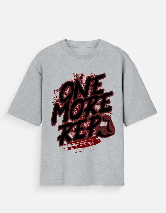 Nauma One More Rep gym graphic unisex oversized T-shirt in melange grey, front view with the bold hand-drawn slogan print across the chest