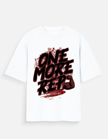 Nauma One More Rep gym graphic unisex oversized T-shirt in white, front view with the bold hand-drawn slogan print across the chest
