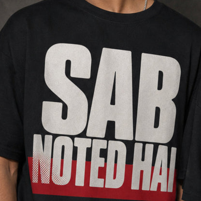 Sab Noted Hai print close-up on black oversized t-shirt