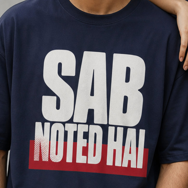 Sab Noted Hai print close-up on navy blue oversized t-shirt