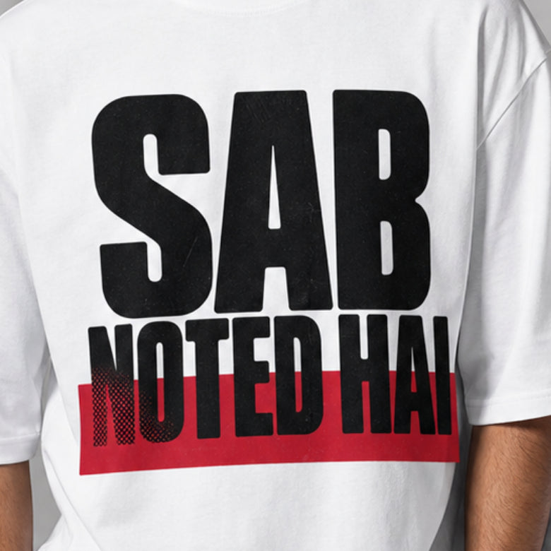 Sab Noted Hai print close-up on white oversized t-shirt