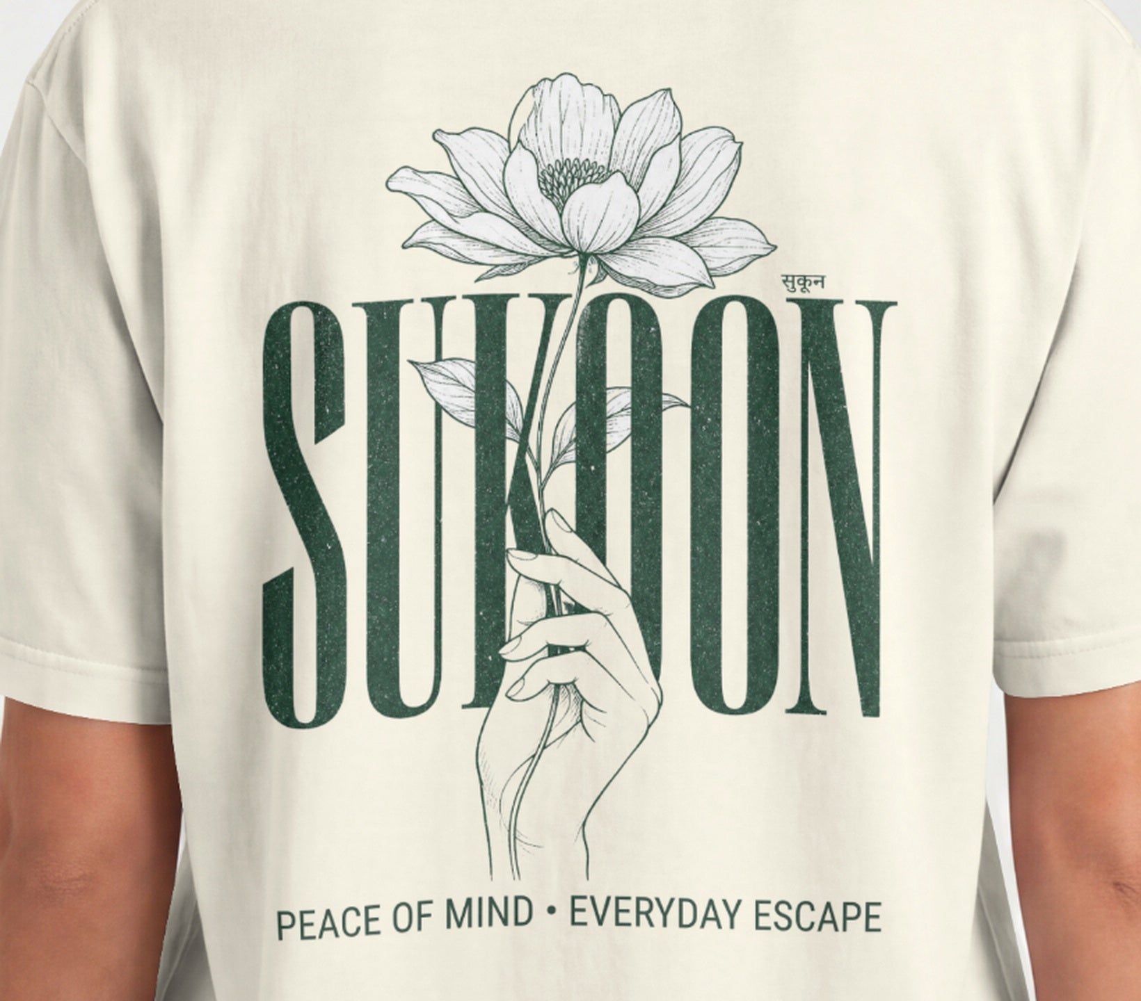Closeup of Nauma Sukoon oversized t-shirt back print in off white with lotus flower and hand illustration