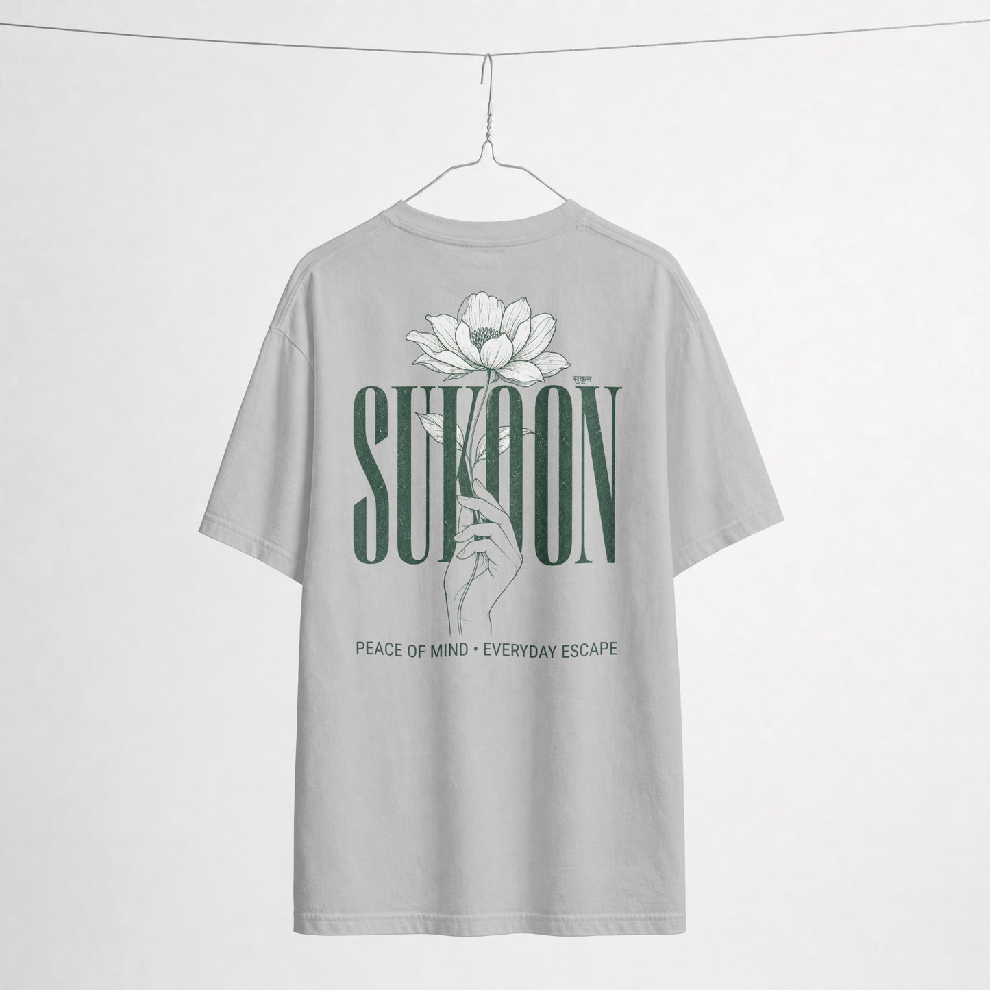 Nauma Sukoon oversized t-shirt in melange grey on a hanger, back print with lotus flower and hand illustration