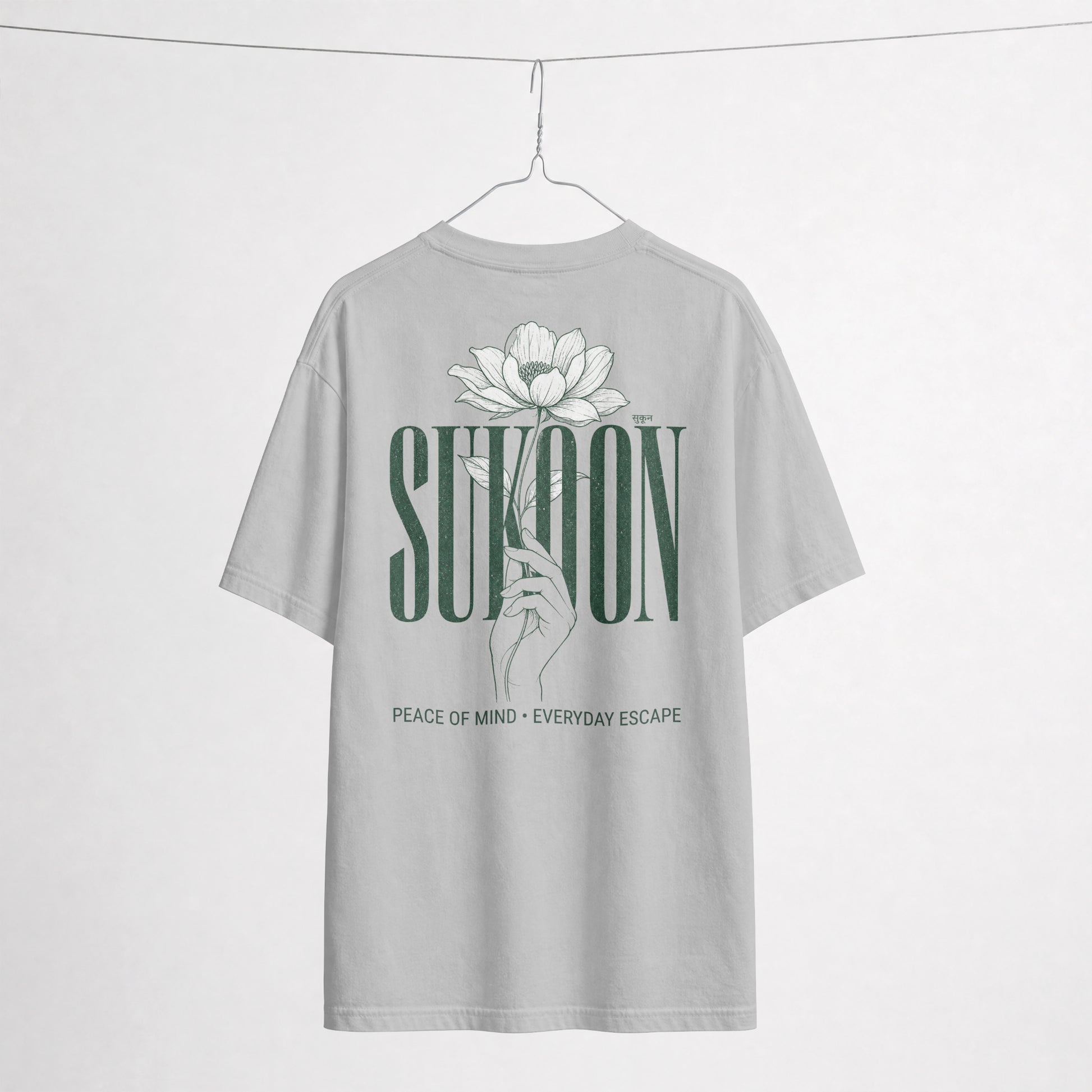 Nauma Sukoon oversized t-shirt in melange grey on a hanger, back print with lotus flower and hand illustration
