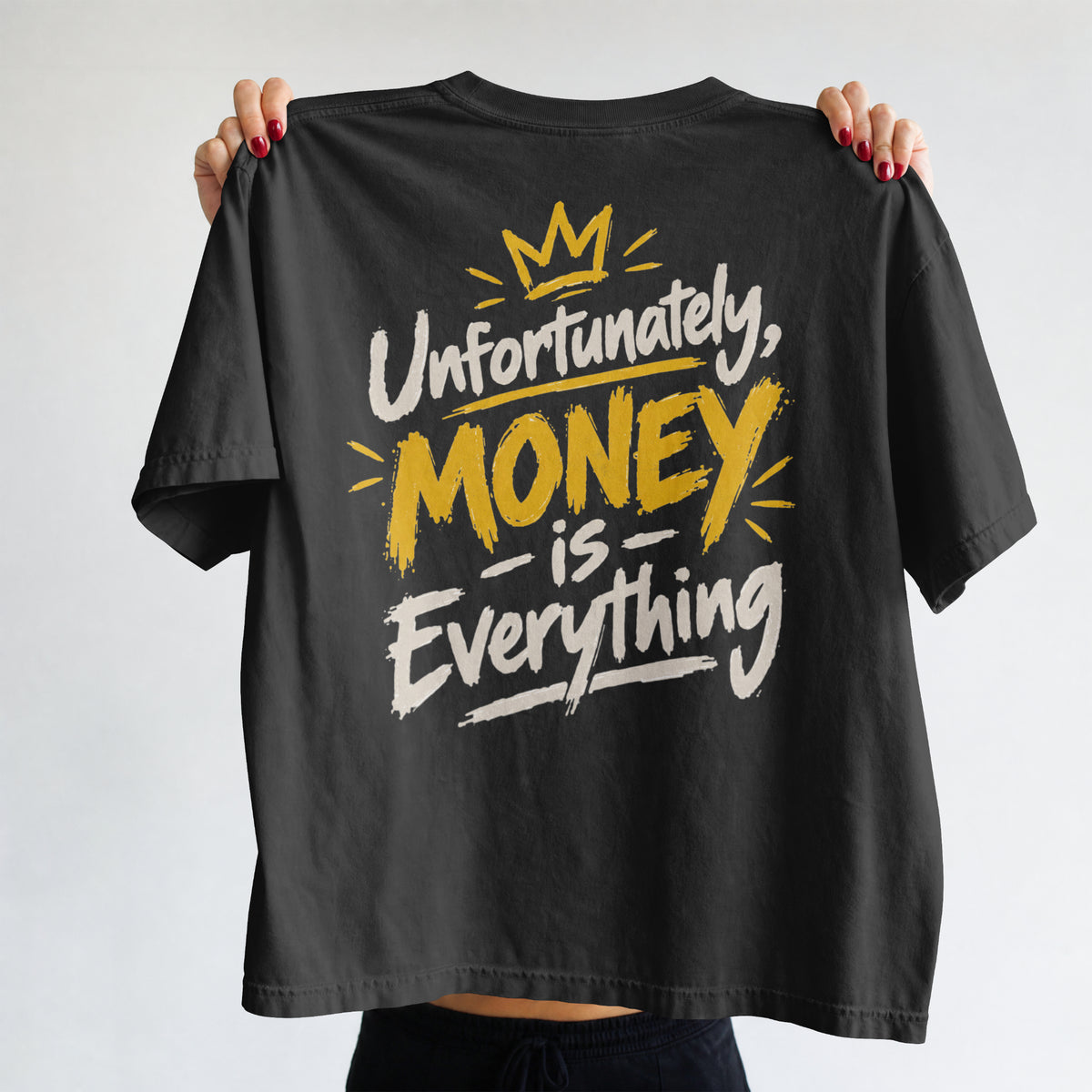 Black Unfortunately Money Is Everything oversized T-shirt held up to show the light back slogan print with MONEY in mustard yellow