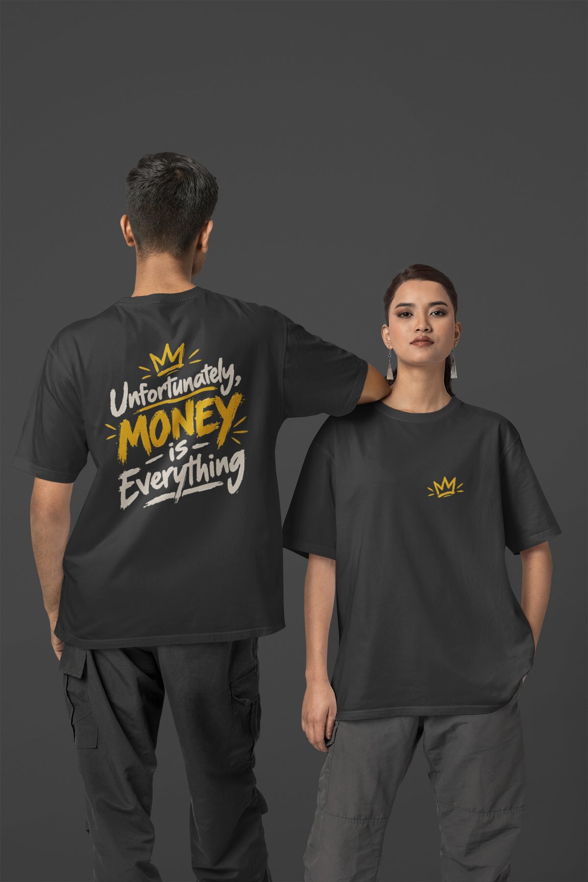 Black Unfortunately Money Is Everything oversized T-shirt on a man and woman, light back slogan print with MONEY in mustard yellow, small crown on the front chest